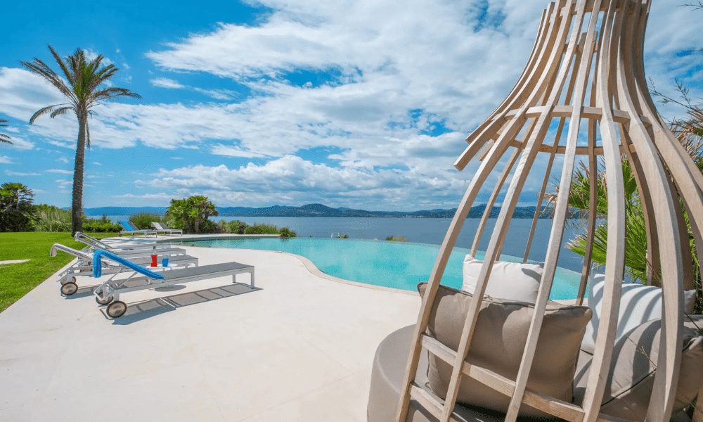 Designer dining area opening onto terrace with ocean backdrop